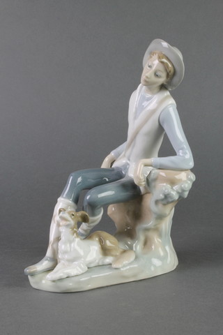 A Lladro figure of a huntsman and hound 8" 