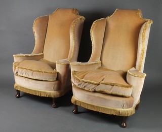 A pair of Queen Anne style winged armchairs upholstered in yellow draylon 