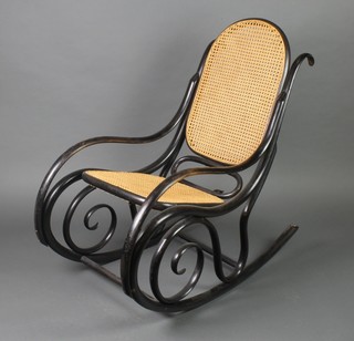 A Thonet style ebonised rocking chair with woven cane seat and back 