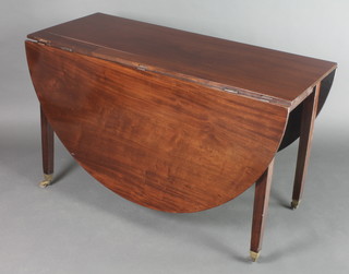 A Georgian mahogany oval drop flap dining table raised on square tapering supports 29"h x 48"l x 19" when closed x 65" when extended