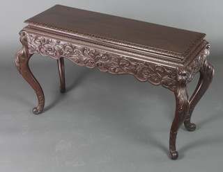 An Edwardian rectangular carved mahogany free standing stool with carved apron, raised on cabriole supports 23"h x 38"w x 16"d 