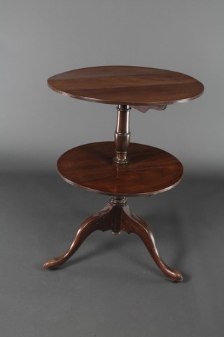 A Victorian mahogany circular 2 tier drop flap dumb waiter, raised on gun barrel and tripod supports 31"h x 22", the upper section when closed 6" x  23 1/2" when opened, the lower section 6 1/2" when closed x 21" when opened 