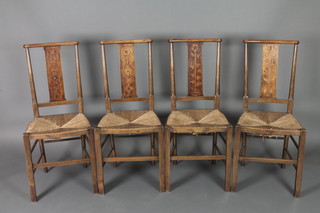 A set of 4 Edwardian Art Nouveau inlaid mahogany slat and bar back bedroom chairs, the slats with inlaid floral decoration and woven rush seats, raised on turned supports with turned stretchers 