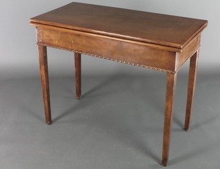 A Georgian style rectangular walnut tea table with feather and crossbanded top, raised on square tapering supports 29"h x 36"w x 17"d 