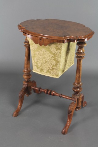 A Victorian shaped walnut work table fitted a basket, raised on turned supports with H framed stretcher 27"h x 22"w x 15 1/2"d 