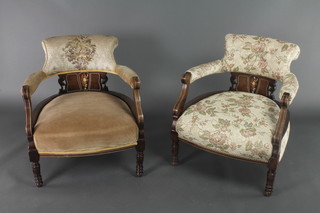 A pair of Edwardian inlaid mahogany tub back chairs with upholstered seats and backs, raised on turned supports