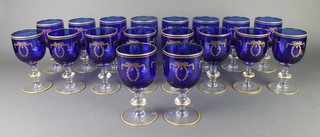 A set of 18 continental blue and gilt decorated baluster wines with swags and festoons 