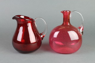 A Victorian cranberry flattened baluster ewer 6" and a ruby glass jug 