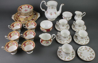 A Royal Albert Lady Hamilton tea set comprising 6 tea cups, a cream jug, sugar bowl, 6 saucers, 6 small plates and 2 sandwich plates together with a Royal Albert Winsome part tea set 
