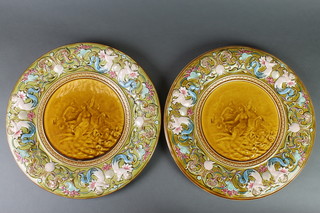 A pair of 19th Century Mettlach chargers the borders with mermaids, shells and scrolls, enclosing classical figures 14" 