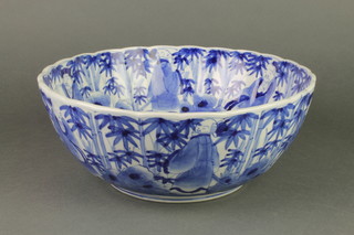 A 19th Century blue and white deep bowl, the interior with a band of figures in landscapes enclosing 2 carp 11 1/2" 