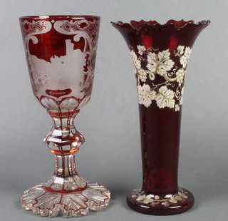 A 19th Century red flash glass goblet decorated with German townscapes 11" together with a red glass vase with vinous decoration 