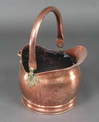 A copper helmet shaped coal scuttle with swing handle 12"