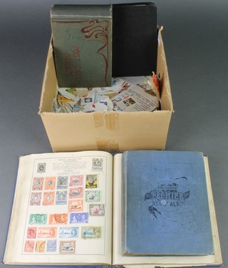 A small album of various postcards, a blue standard stamp album and a blue Premier stamp album, loose stamps etc