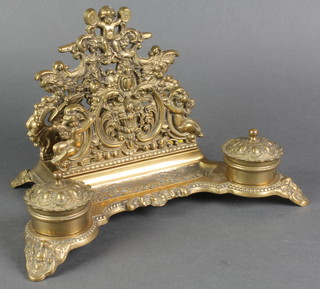 A pierced brass standish incorporating 2 inkwells, pen rest and letter rack 