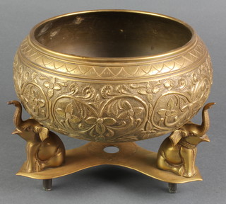 A circular Indian brass bowl raised on a triform base with elephant supports 7" 