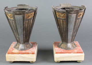 A pair of Art Deco waisted spelter urns raised on 2 colour marble bases 9"  