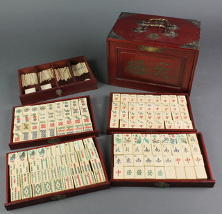 A bone and bamboo mahjong set contained in a hardwood carrying case fitted 5 long drawers 