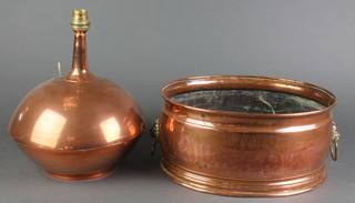 A circular copper table lamp the base marked Atlas Pure Copper, Made in RSA, 9" (dented) together with an oval twin handled copper planter 11 1/2" 