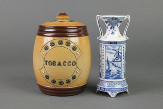 A Doulton Lambeth baluster tobacco jar and cover with portrait medallion 5 1/4" together with a Delft twin handled blue and white vase 5" 