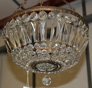 A circular gilt metal light fitting hung circular and cut lozenges 