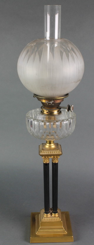 A Victorian style cut glass oil lamp reservoir raised on 4 corinthian column capitals and with stepped brass base, etched glass shade and chimney 31" 