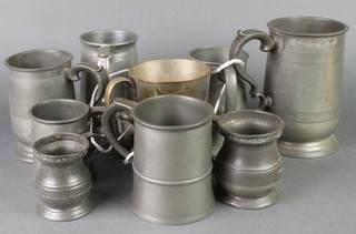 A Victorian quart pewter tankard by Yates and a collection of other pewter tankards 