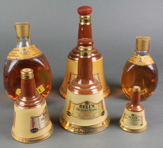 A 26 2/3 fluid oz bottle of Dimple Haig whisky, a 13 1/3 ditto, 4 Wade graduated decanters of Bells Whisky (seals broken) 