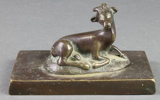 A 19th Century bronze paperweight in the form of a seated faun raised on a rectangular base 4 1/2" 