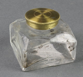 A square glass inkwell with gilt metal cap