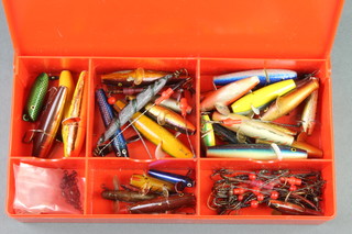 A collection of various Devon Minnows lures, boxed