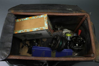 A tackle box containing a collection of various reels 