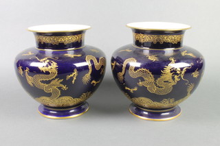 A pair of 20th Century Bavarian blue ground baluster vases, the gilt decoration with dragons chasing the flaming pearl 9" 