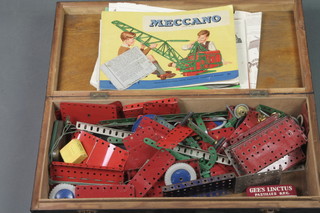 A box containing various and red and green Meccano, an Outfit no.1 brochure, instructions for Meccano No.1a outfit, ditto no.3 