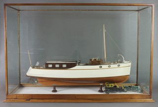A scale model of a steam cruiser contained in a glass cabinet 24"h x 36"w x 12"d 