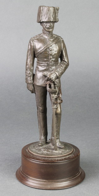 A bronze figure of a standing cavalryman raised on a socle base 10" 