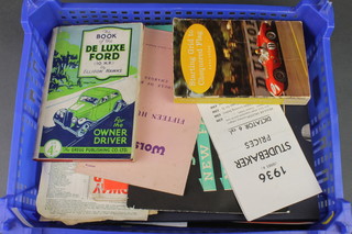 Stirling Moss, a signed autograph, together with a box containing various motoring programmes, Isle of Man and other related ephemera
