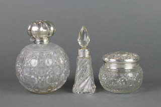 An Edwardian silver mounted spherical cut glass scent bottle, Birmingham 1903 4 1/4", a ditto mounted jar, a tapered scent
