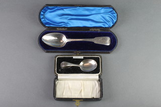 A Victorian cased silver dessert spoon with chased decoration Dublin 1848, together with a cased Sterling christening spoon 