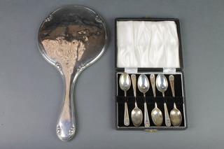 A cased set of 6 silver coffee spoons with shell handles, Sheffield 1939, a silver backed dressing table mirror 