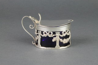 An Edwardian oval pierced silver mustard with blue glass liner, Birmingham 1900 together with a plated spoon