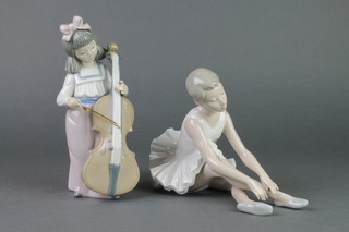 A Nao figure of a girl cello player 7" and a ditto of a seated ballerina 7 1/2" 