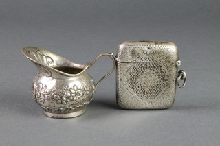 A silver vesta and a Continental silver cream jug 