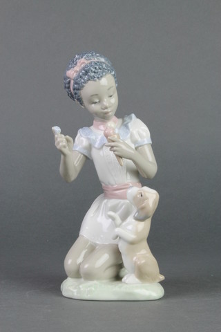 A Lladro figure of a young girl eating an ice cream feeding a puppy. 5836 7" 