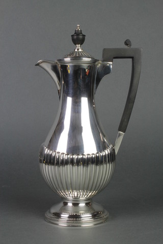 A silver demi fluted baluster chocolate pot with ebony mounts, Sheffield 1923, gross 496 grams
