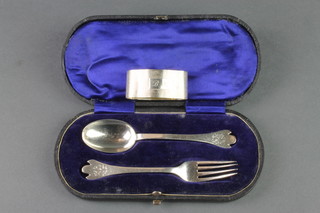 A cased christening fork and spoon Sheffield 1918, 50 grams and a silver engine turned napkin ring 20 grams