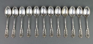 A set of 12 silver coffee spoons with pierced scroll handles, Sheffield 1912, 158 grams