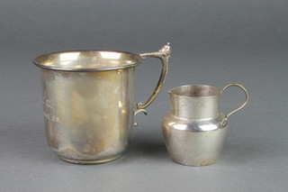 A silver mug with fancy acorn handle, a ditto jug, 102 grams