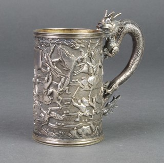 An early 20th Century cast silver mug with dragon handle and extensive fighting scene, 160 grams in a fitted wooden box