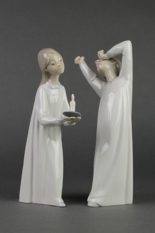 2 Lladro figures of a girl with chamberstick. 4868 8 1/2" and a yawning boy. 4870 9" 